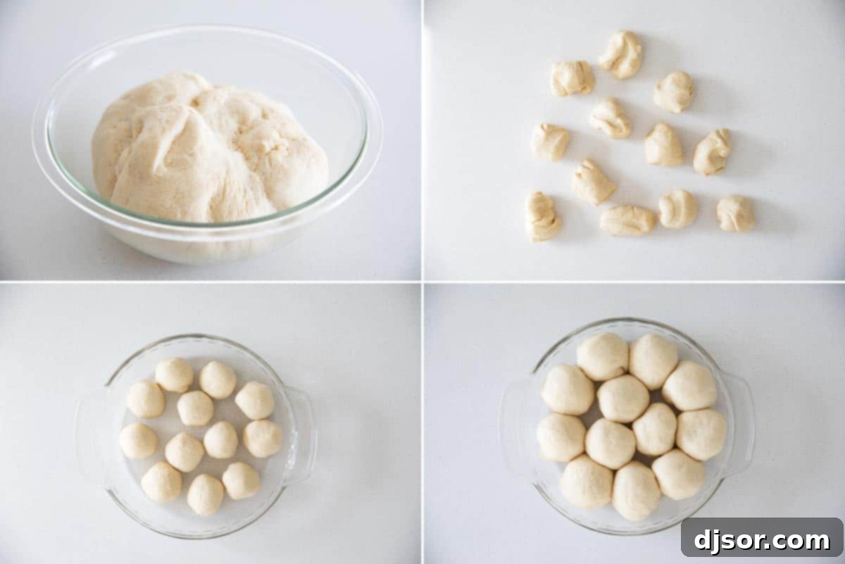 Close-up of dough being shaped into small balls and arranged in a pie dish for the second rise.