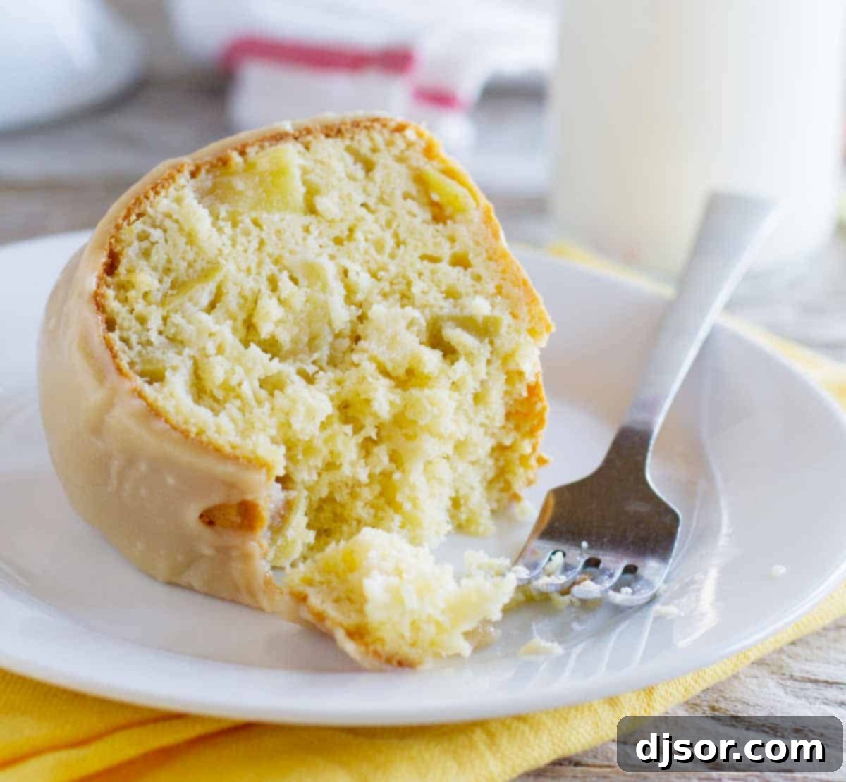 This easy, yet impressive looking Apple Bundt Cake with Caramel Frosting is perfect to serve to holiday guests. Don’t skip the caramel frosting - it totally makes this cake! slice of apple bundt cake with a fork