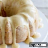 Spiced Apple Bundt with Decadent Caramel Glaze 2 full Apple Bundt Cake with Caramel Frosting dripping down the sides