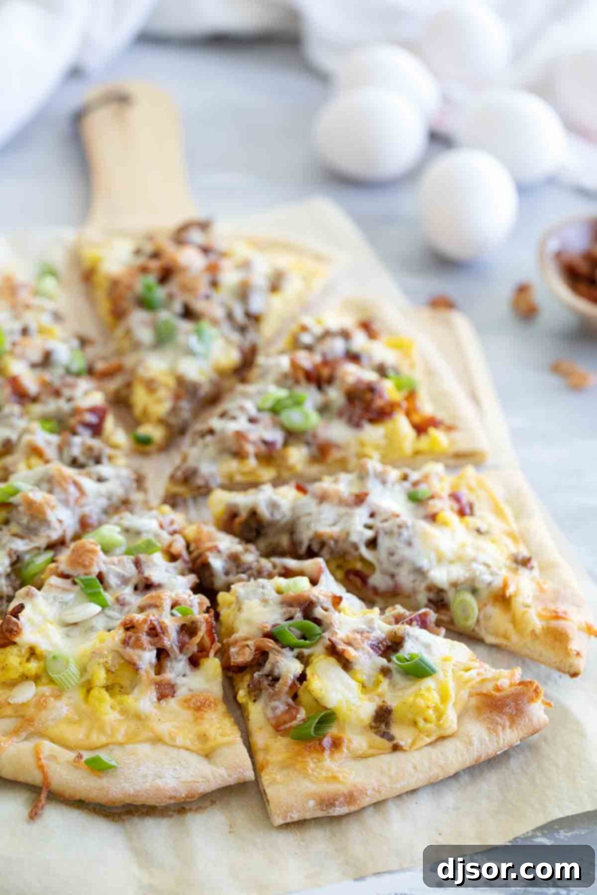 Sliced Breakfast Pizza Ready to Serve View of full breakfast pizza cut into slices, showcasing the layers of toppings.