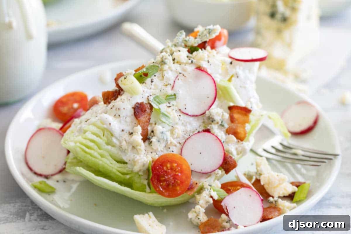 The classic wedge salad: cool, crisp, and flavorful, perfect for any meal. A beautifully plated wedge salad topped with creamy blue cheese dressing, crispy bacon, and fresh tomatoes.