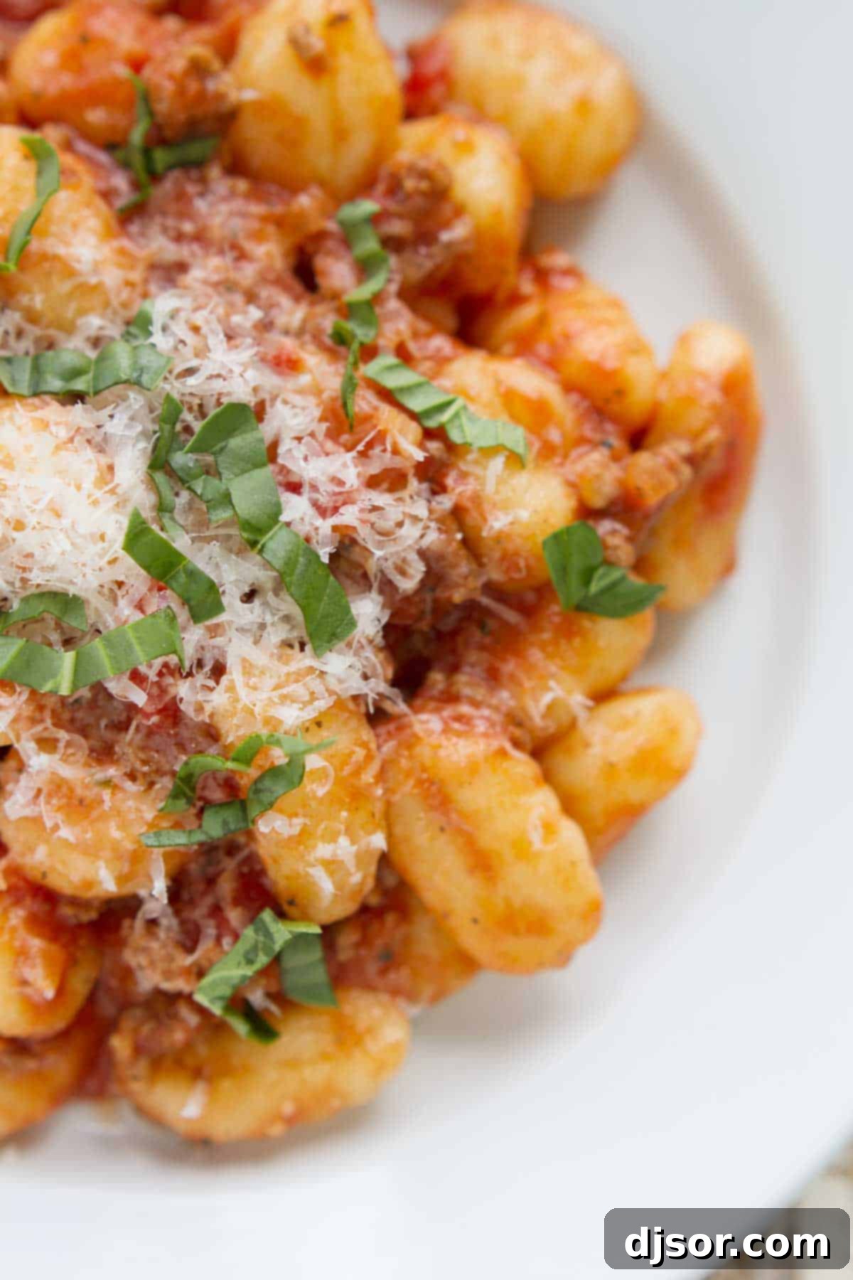 Pillowy Gnocchi with Rich Meat Ragu 3 Gnocchi topped with a meat sauce, parmesan, and basil.