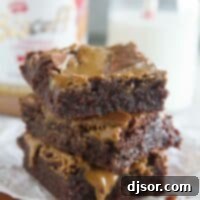 Lotus Biscoff Brownie Delight 7 Stack of Biscoff Brownies with a jar of Biscoff spread in the background.
