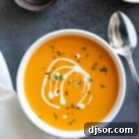 Creamy Sweet Potato Bliss 2 Bowl of sweet potato soup drizzled with cream.