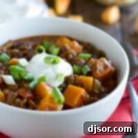 Hearty Butternut and Beef Chili 2 Bowl of butternut squash chili with ground beef topped with sour cream.