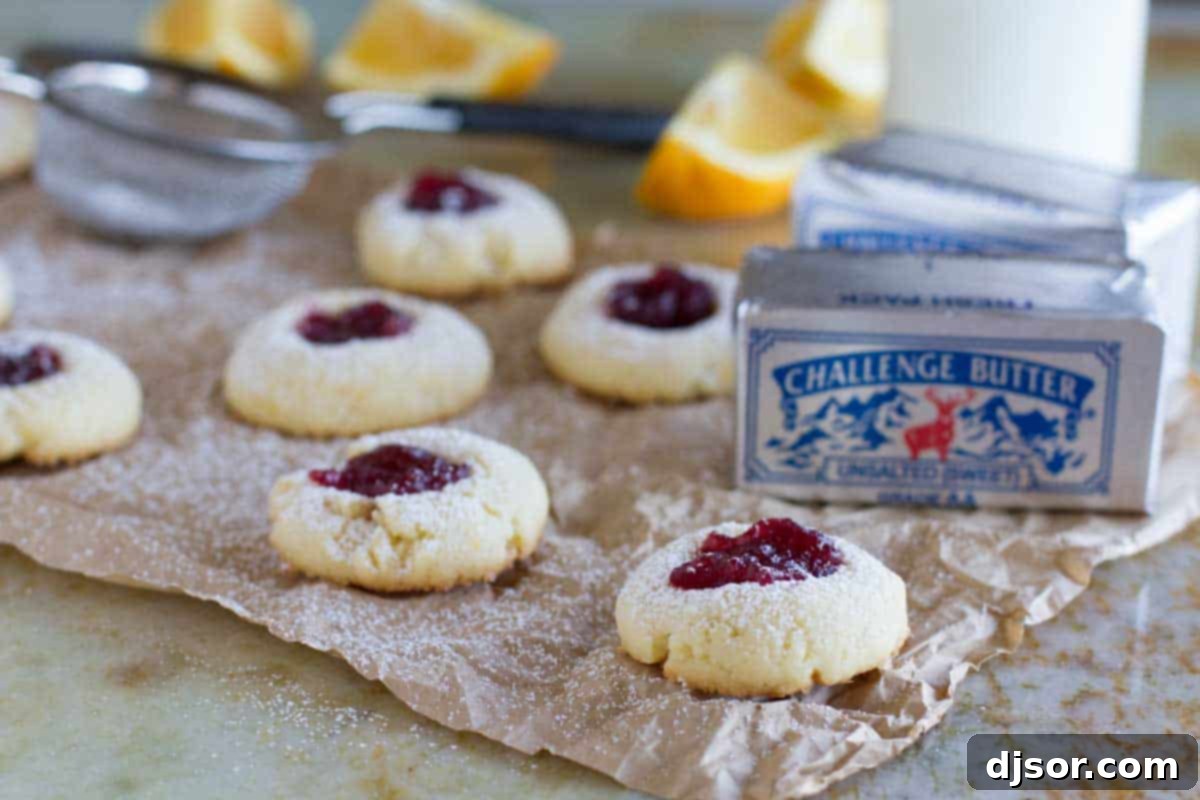 Close-up of a festive Cranberry Thumbprint Cookie with orange zest and cranberry sauce