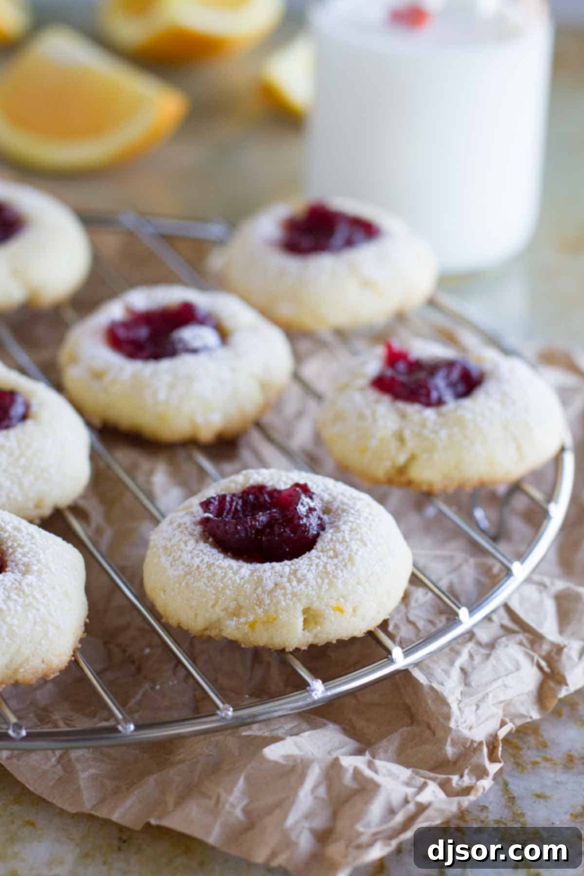 Cranberry Thumbprint Cookies cooling on a wire rack, dusted with powdered sugar