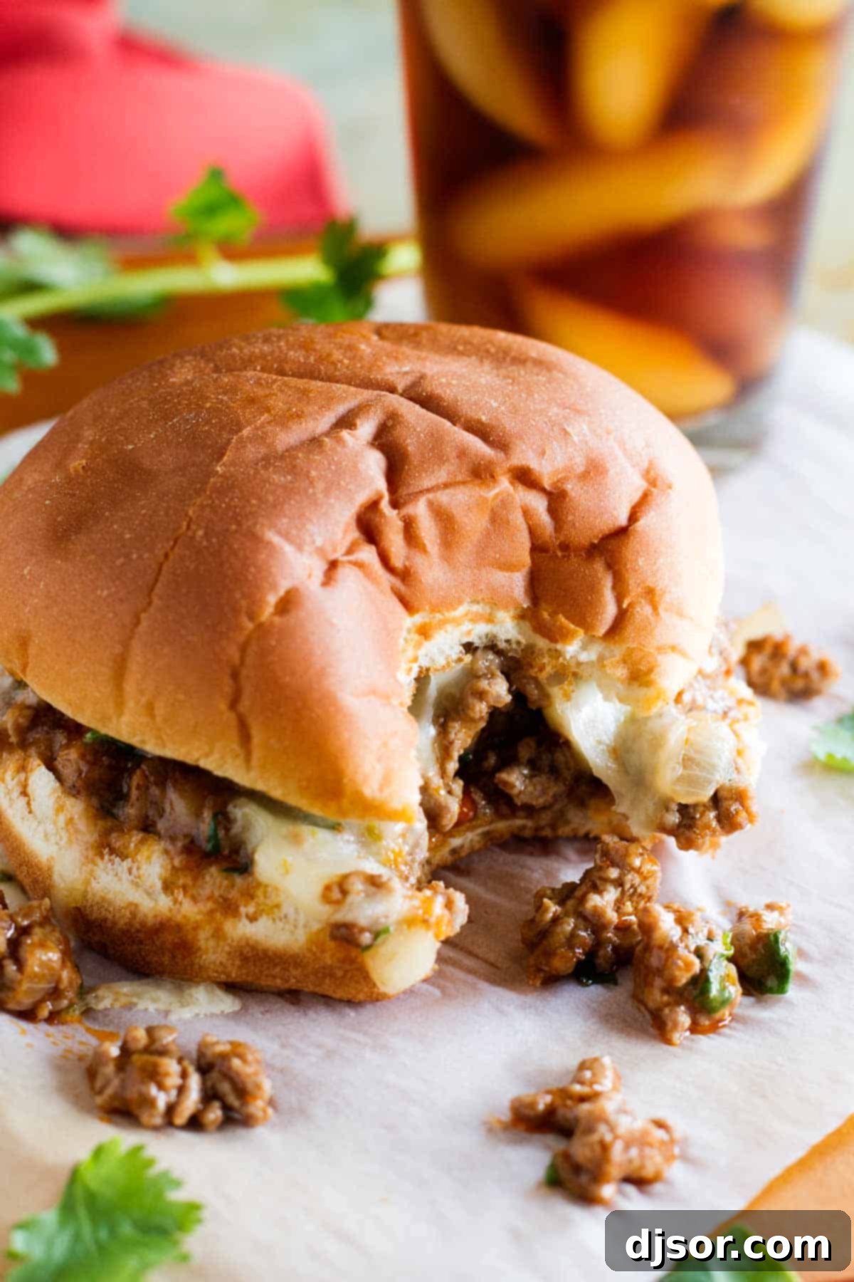 Easy steps for creating the best Enchilada Sloppy Joe recipe. Step-by-step process of making Enchilada Sloppy Joes, showing the ground beef mixture with enchilada sauce.