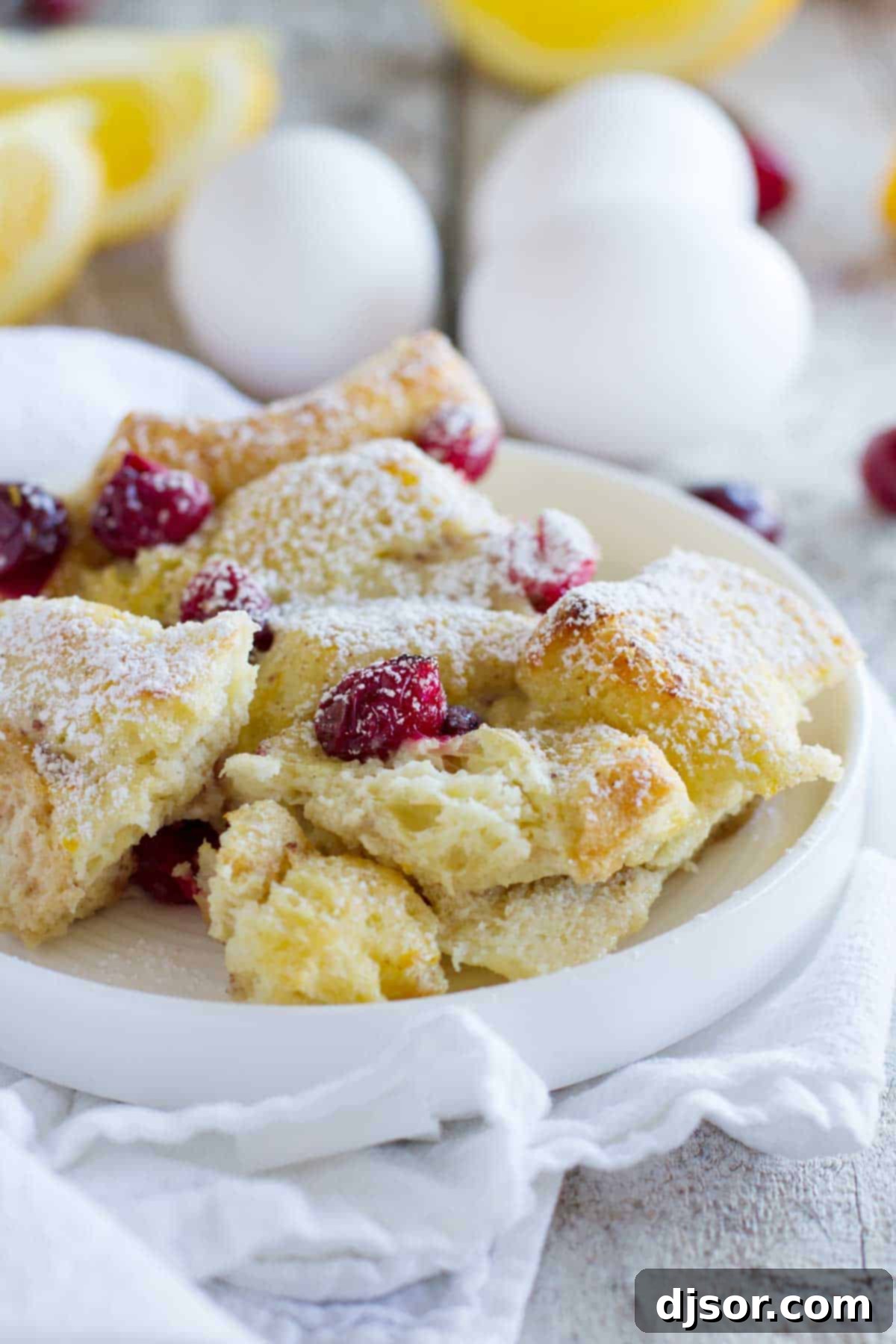 Overnight Cranberry Orange French Toast Bake 2 Cranberry Orange Baked French Toast Casserole on a plate, made with fresh cranberries and oranges.