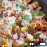 Hawaiian One Pan Pasta with ham, bacon, pineapple, and cilantro.