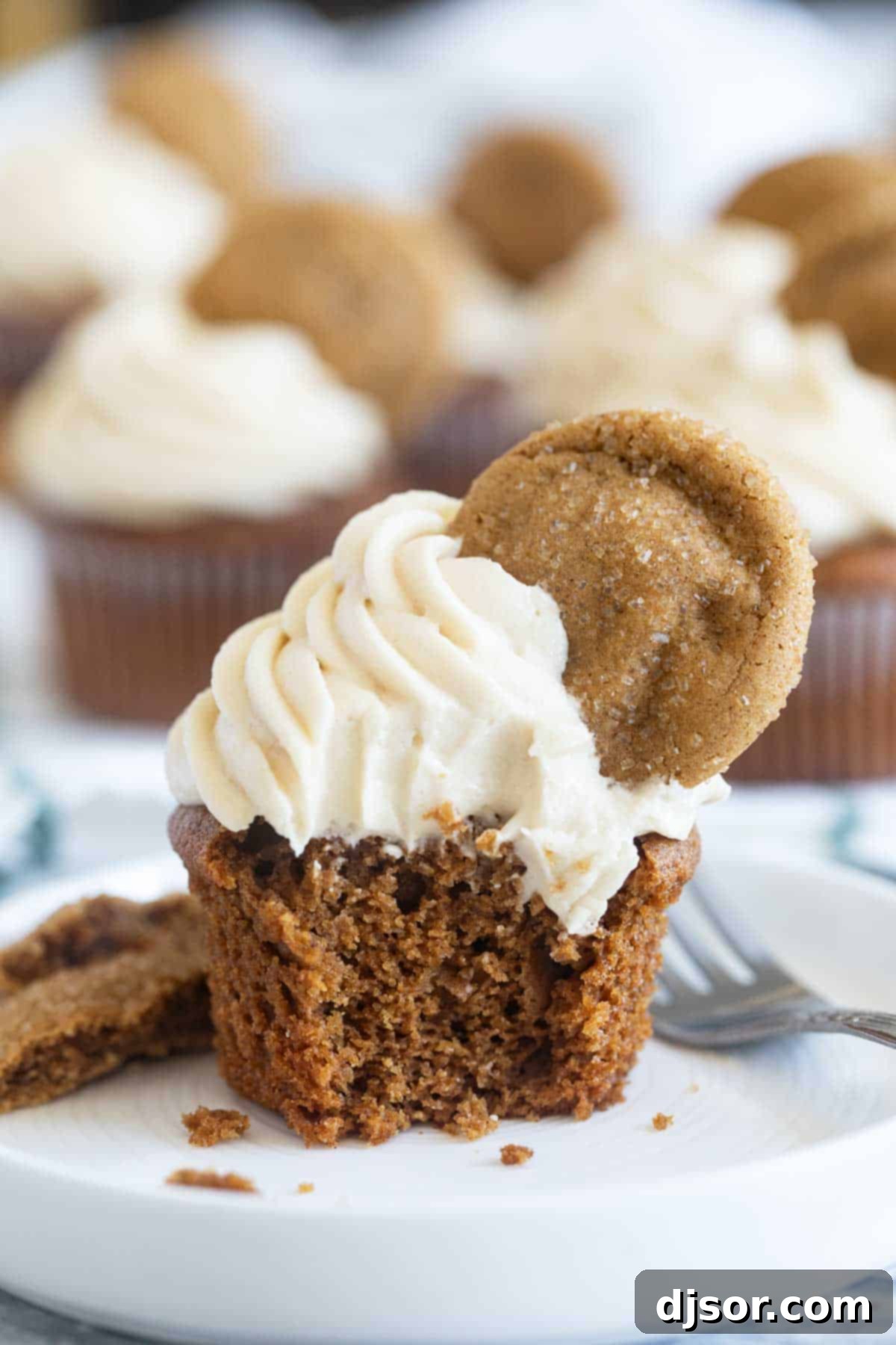 Warm Spiced Gingerbread Treats 7 Gingerbread cupcake with a bite taken from it to show interior texture.
