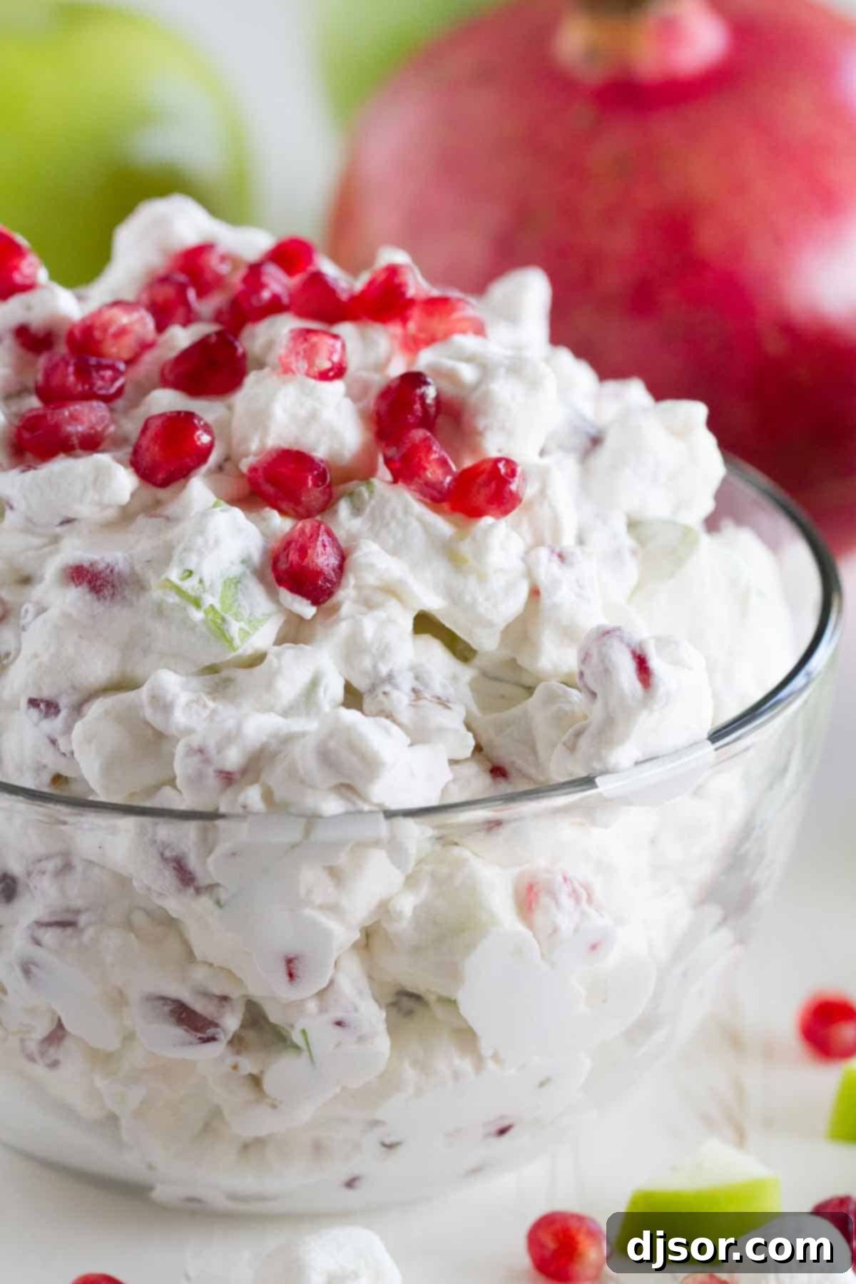 Vibrant Apple Pomegranate Salad in an elegant glass bowl, ready to serve.
