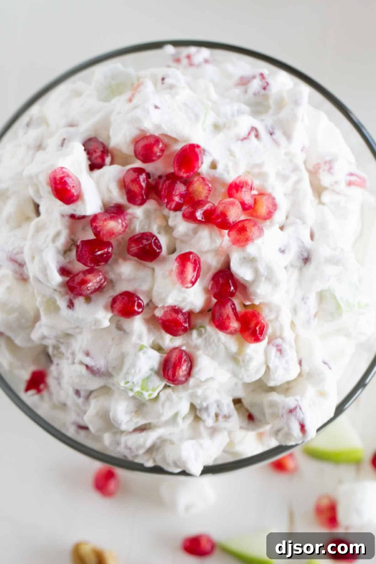 Overhead shot of the finished Apple Pomegranate Salad, garnished with extra pomegranate seeds.