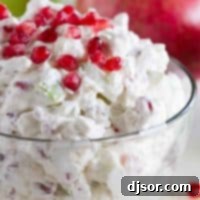 Apple Pomegranate Salad in a beautiful glass bowl, garnished for serving.