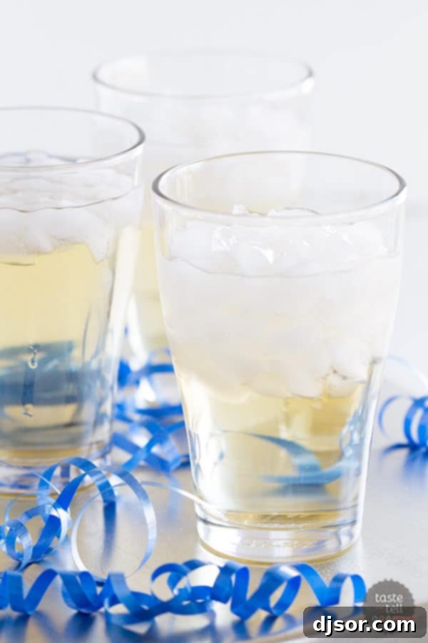 A vibrant red non-alcoholic holiday punch with orange slices and cranberries, perfect for festive gatherings.