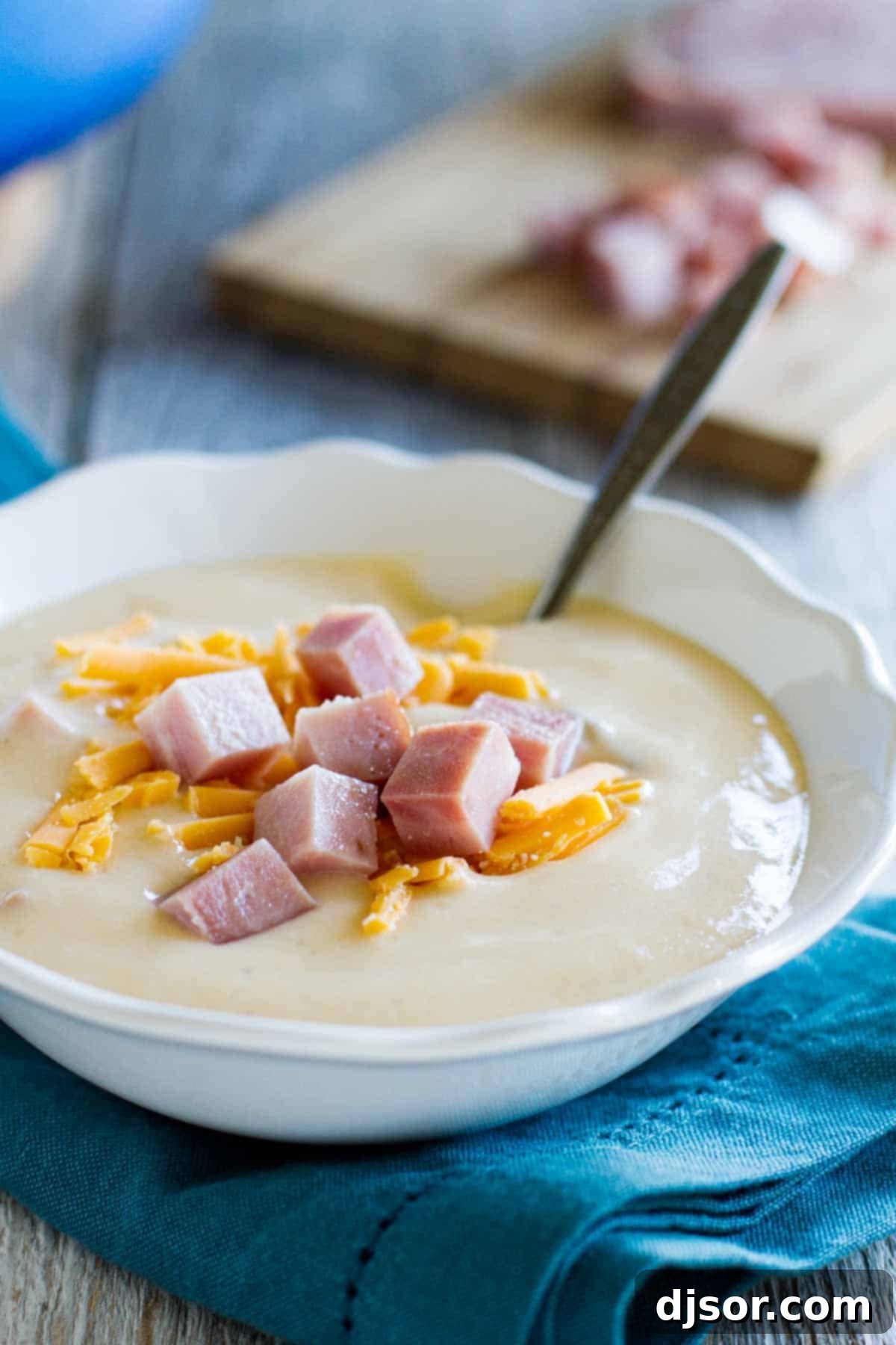 Serve this delightful Cauliflower Soup with Ham and Cheese with your favorite sides bowl of cauliflower soup topped with ham and cheese, ready for serving