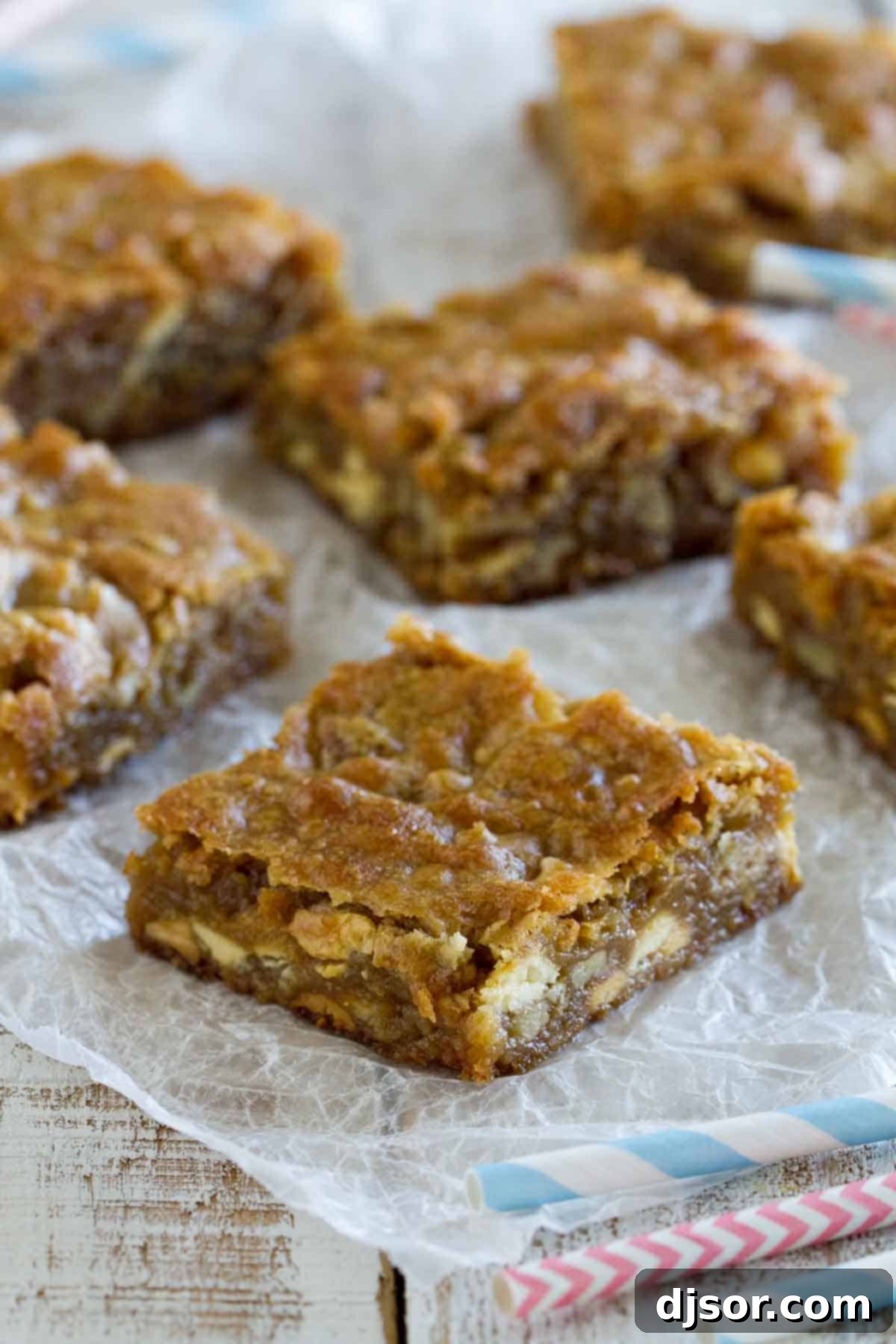 Homemade Blondie Bars Ready to Serve Freshly baked blondies cut into squares, arranged on crumpled parchment paper.