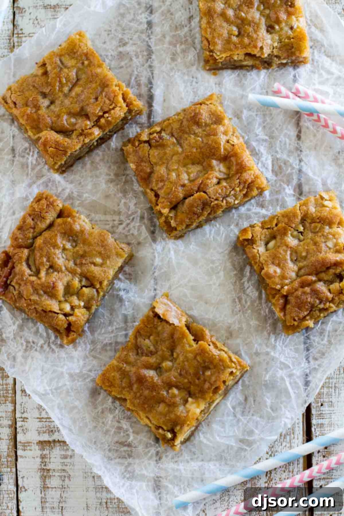 Sliced Blondies with Pecans and Toffee An overhead view of perfectly sliced blondie bars, showing the rich texture and inclusions of pecans, white chocolate, and toffee.