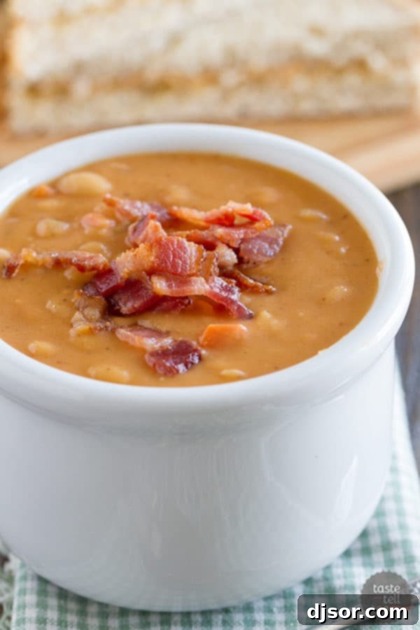 Hearty Bean and Bacon Soup 4 Overhead view of a hearty bowl of homemade bean and bacon soup, garnished with crispy bacon and fresh herbs, perfect for a warming meal.
