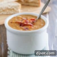 Hearty Bean and Bacon Soup 6 A beautifully presented bowl of homemade bean and bacon soup, ready to be enjoyed, showcasing the rich colors and textures of its fresh ingredients.