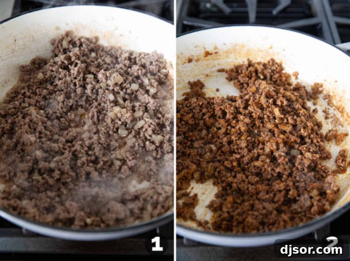 Ground beef cooking in a large cast iron pot with chopped onions and minced garlic, before spices are added to create the Chili Mac base.