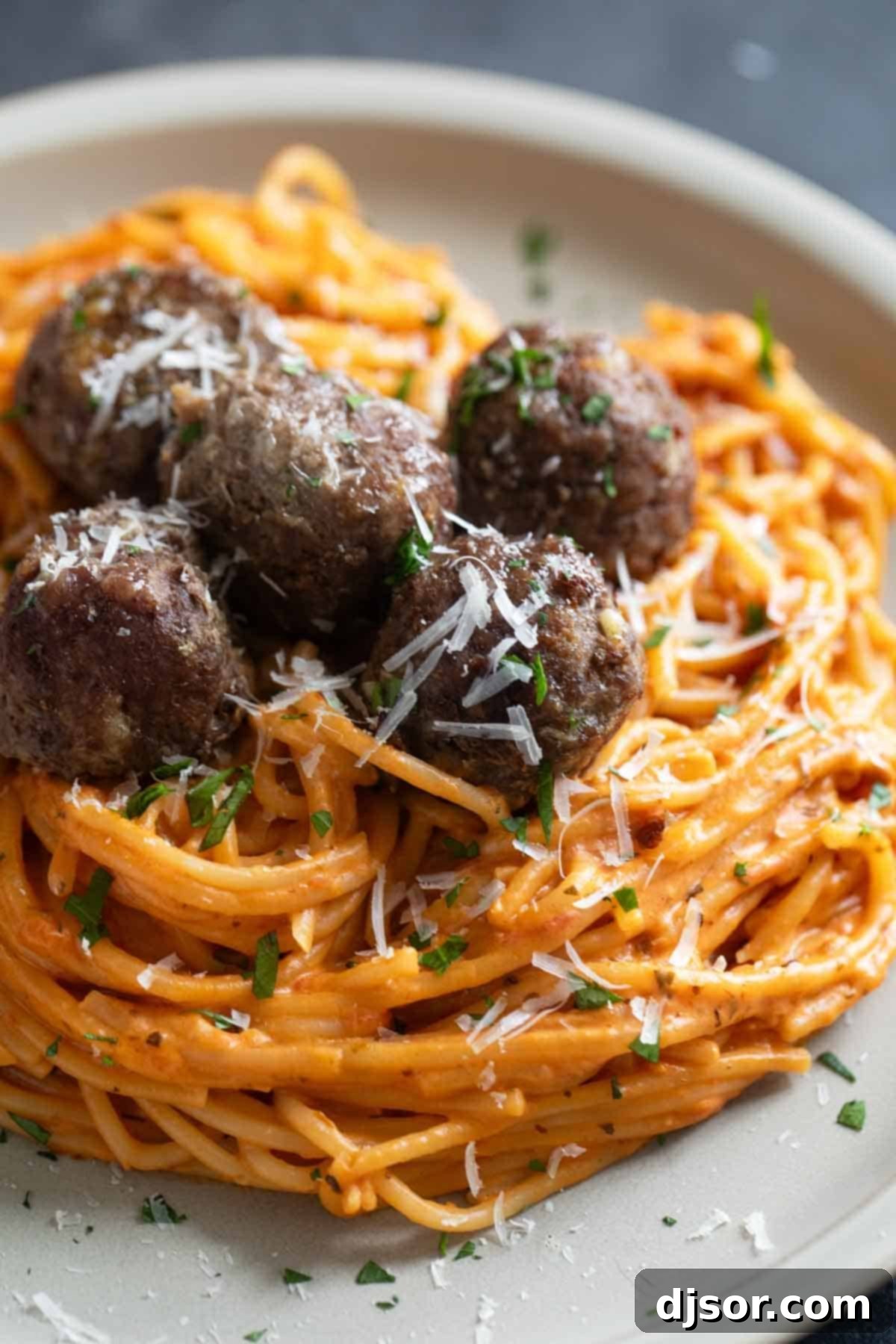 One Pan Creamy Meatball Spaghetti 2 Creamy One Pot Spaghetti topped with baked meatballs, parsley, and parmesan cheese, served in a shallow bowl.