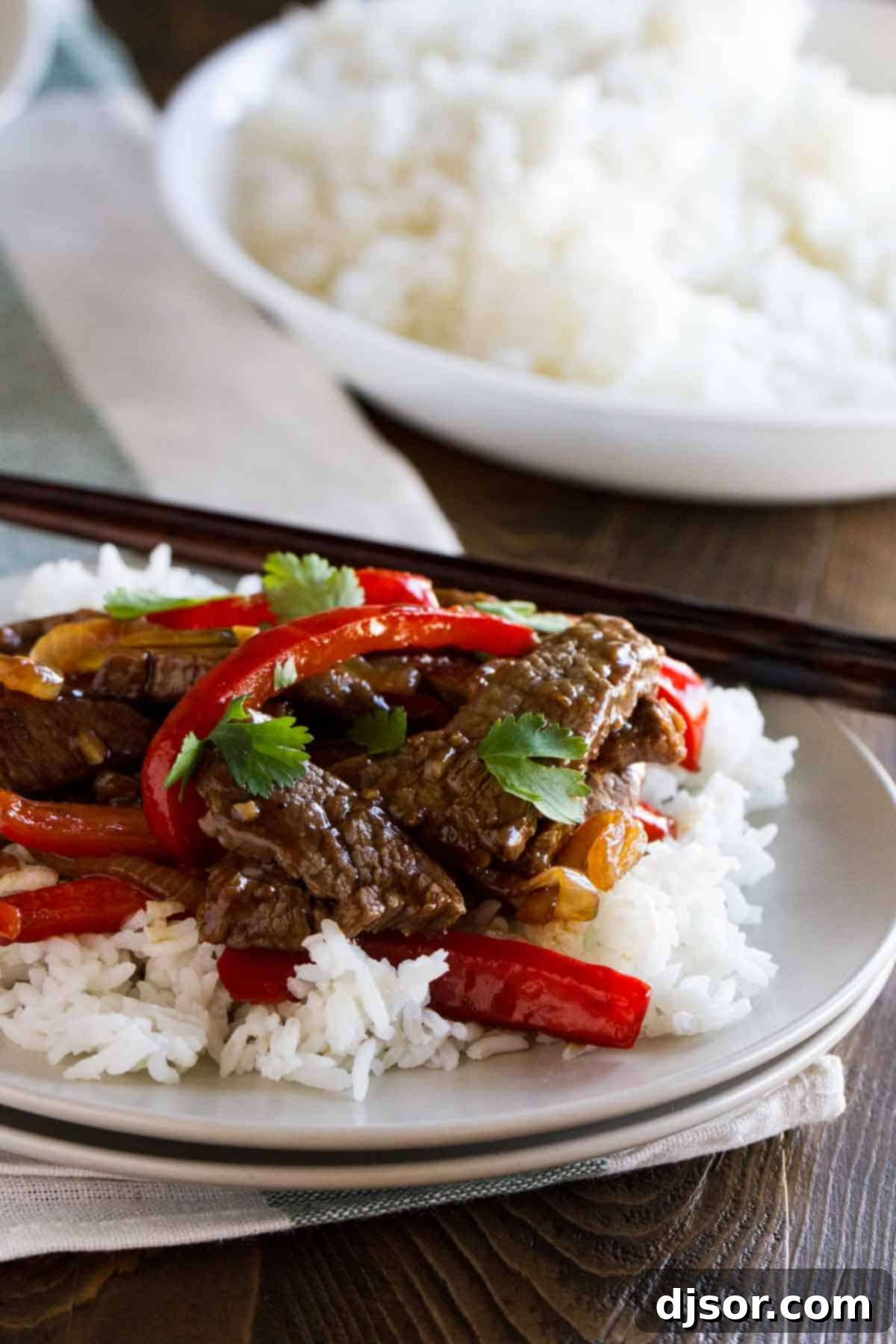 Plate with a serving of rice topped with steak stir fry
