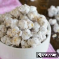 Peanut Butter Chocolate Snow Popcorn 2 White bowl filled with muddy buddy popcorn.