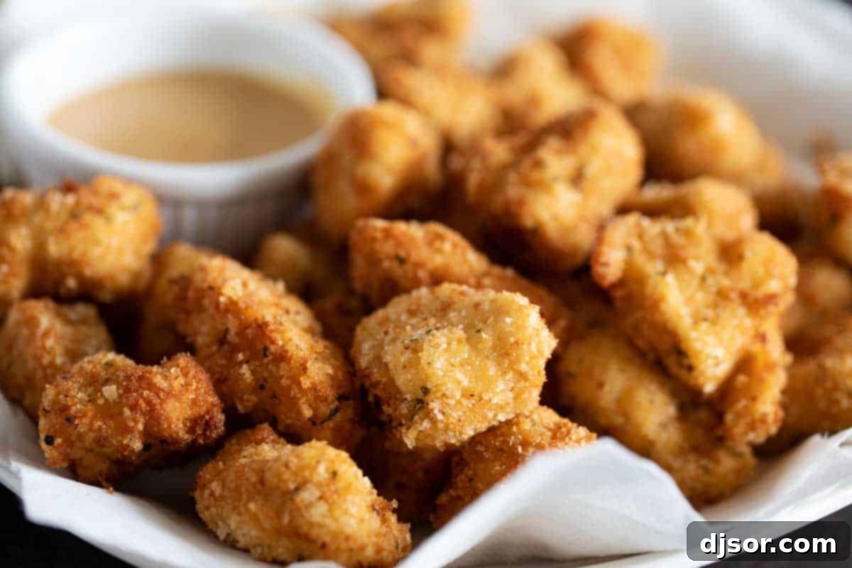 plate full of crispy Homemade Chicken Nuggets with dipping sauce