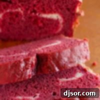 Slices of red velvet quick bread showing texture and a creamy filling.