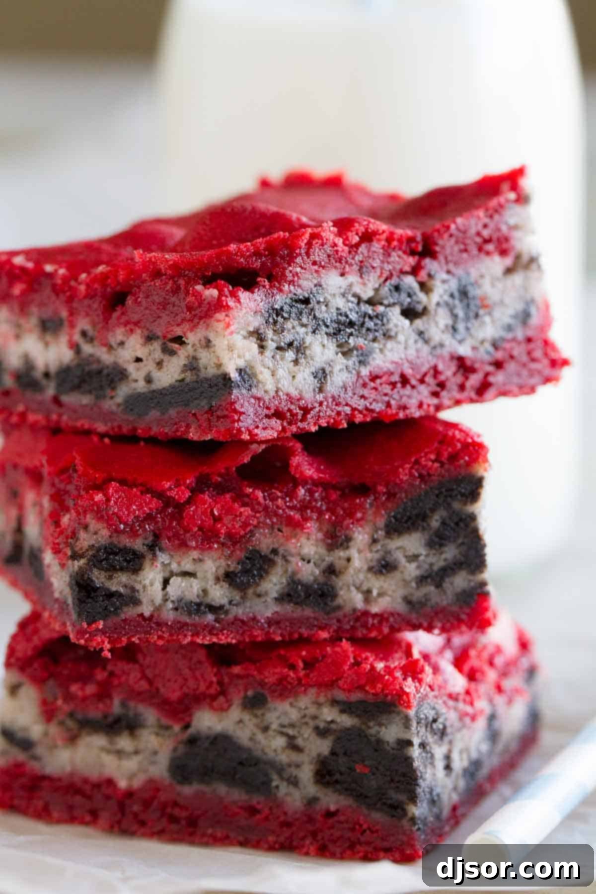 Decadent Oreo Cream Cheese Stuffed Red Velvet Brownies 4 Three Oreo Cream Cheese Stuffed Red Velvet Brownies stacked on top of each other.