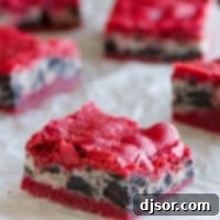 Decadent Oreo Cream Cheese Stuffed Red Velvet Brownies 6 Oreo Cream Cheese Stuffed Red Velvet Brownies on a piece of white parchment paper.