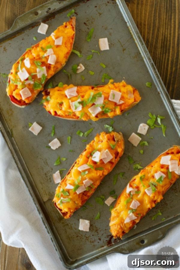 Close-up of creamy, cheesy Twice Baked Sweet Potatoes with Canadian Bacon on www.tasteandtellblog.com