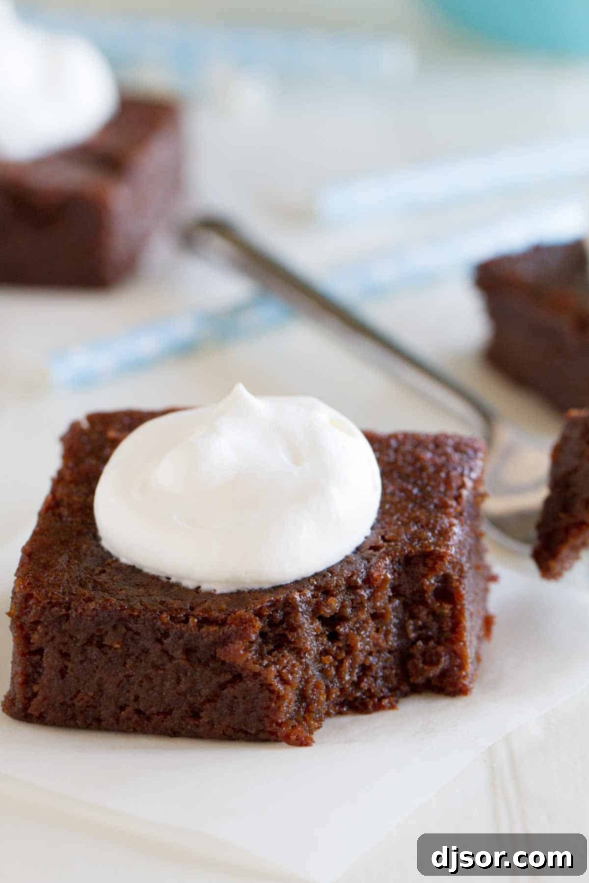 Fudgy Coconut Flour Brownies 4 A stack of Grain Free Coconut Flour Brownies, showcasing their thick, rich texture ready to be enjoyed.