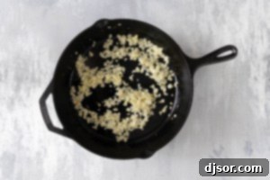 Onion and garlic cooking in a skillet.