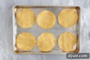 Tostada shells on a baking sheet.