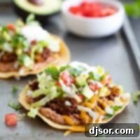 Beautifully plated ground beef tostada with fresh toppings