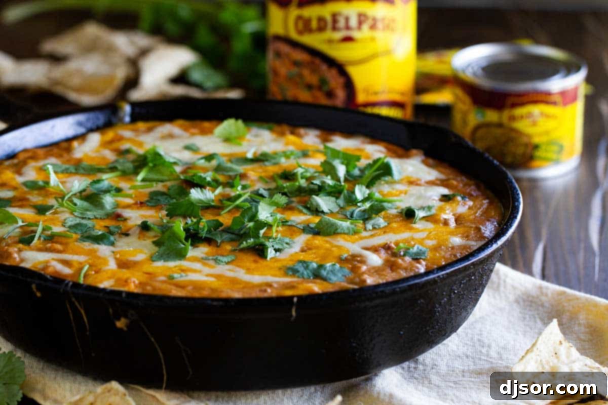 Hot Beef and Bean Dip: The Ultimate Game Day Appetizer Delicious Hot Beef and Bean Dip served warm in a cast iron skillet, perfect for sharing.