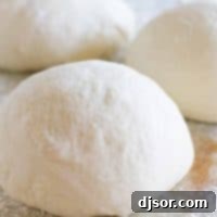 balls of pizza dough with flour