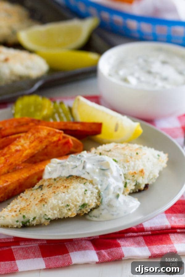 Close-up of a perfectly baked Panko-crusted tilapia fillet with a dollop of homemade tartar sauce, ready to be enjoyed.