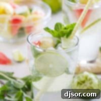 Virgin Mojito (Nojito) with a striped straw and fresh mint.