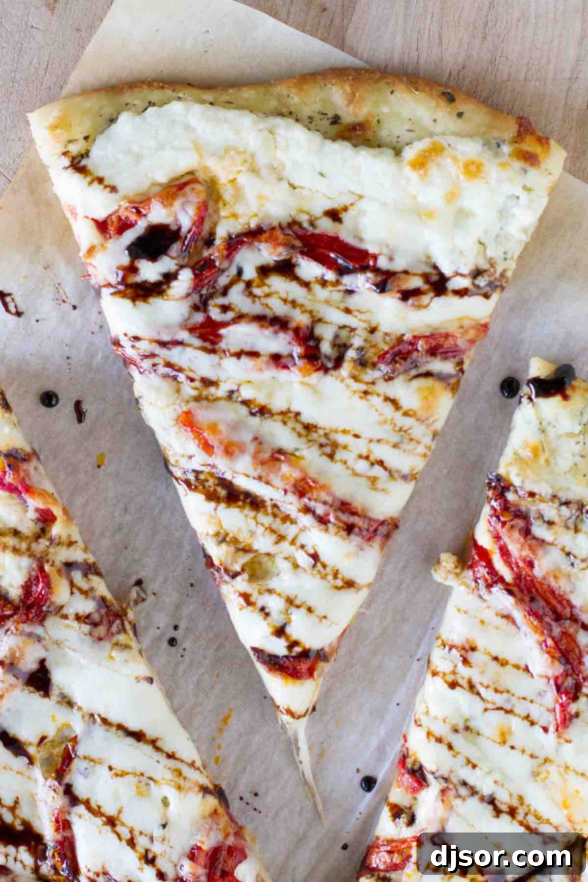 The Finishing Touch: Balsamic Drizzle overhead view of a single slice of white pizza with roasted tomatoes, drizzled with balsamic