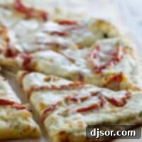 Creamy White Pizza with Sun-Kissed Tomatoes 2 slice of white pizza topped with roasted tomatoes
