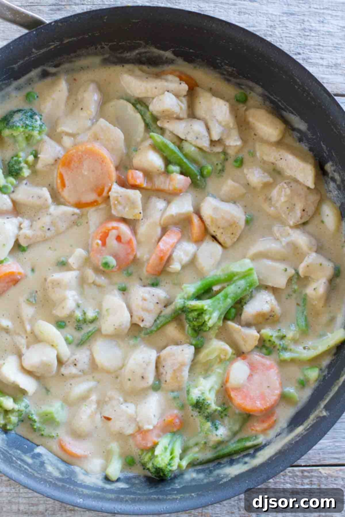 Peanut sauce doesn’t have to be reserved for satay - this Peanut Chicken Stir Fry has a coconut milk and peanut sauce, lean chicken breasts, and lots of veggies. It is the perfect weeknight dinner. skillet with peanut chicken and vegetables