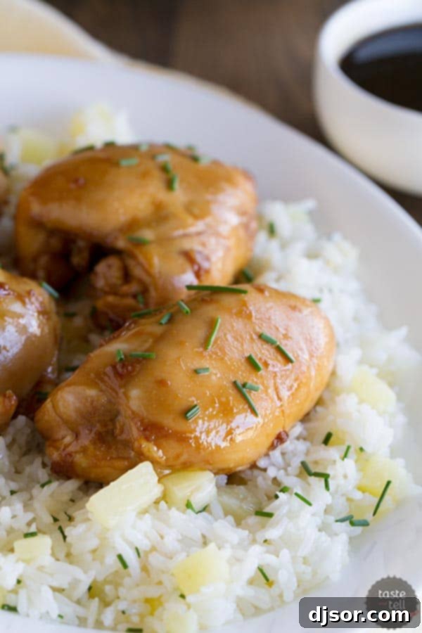 Boneless chicken thighs are coated in a sweet asian-inspired sauce and served over sweet pineapple rice in this Sweet Asian Chicken with Pineapple Rice.