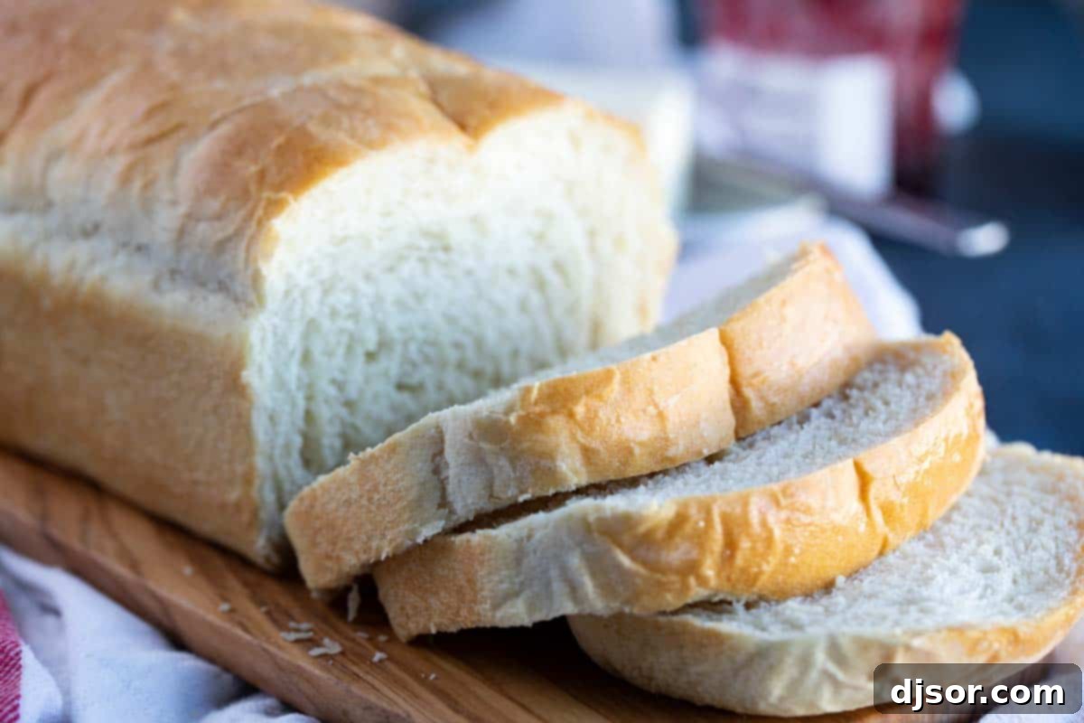 This may be the perfect sandwich bread! This Potato Bread is made with mashed potatoes which make for a loaf of bread that is sturdy, yet soft and fluffy. sliced loaf of potato bread on a cutting board
