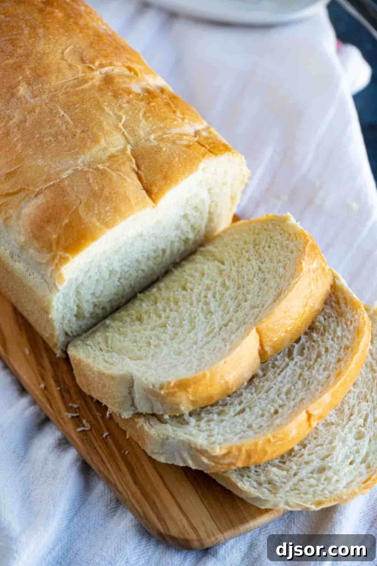This may be the perfect sandwich bread! This Potato Bread is made with mashed potatoes which make for a loaf of bread that is sturdy, yet soft and fluffy. Potato bread on a cutting board with a few slices cut