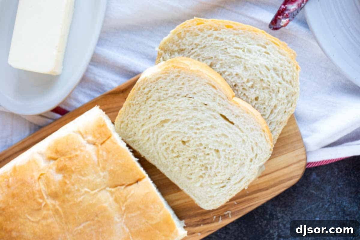 This may be the perfect sandwich bread! This Potato Bread is made with mashed potatoes which make for a loaf of bread that is sturdy, yet soft and fluffy. sliced Potato Bread on a cutting board