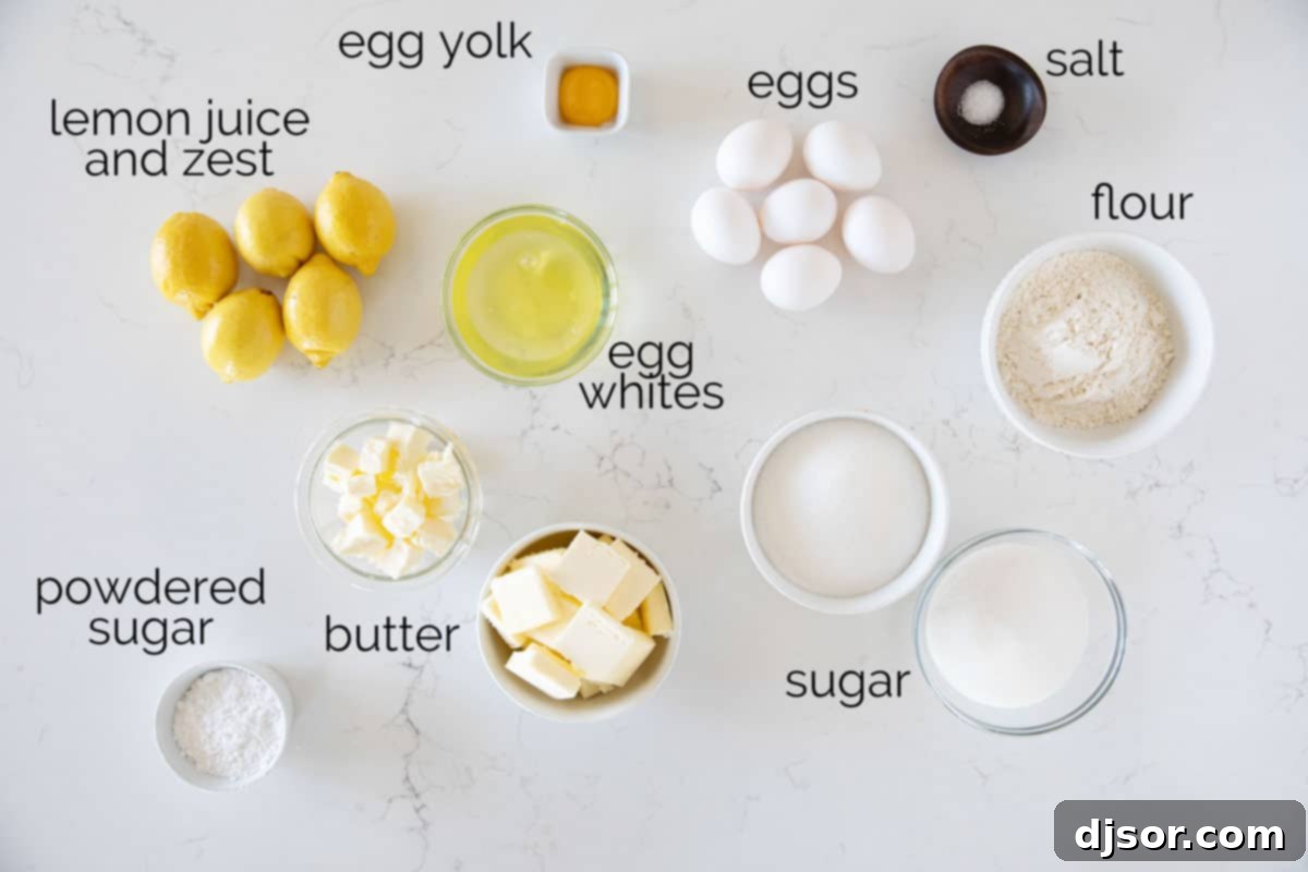 An array of fresh ingredients for French Lemon Tart with Meringue, including lemons, eggs, butter, and sugar, neatly arranged.