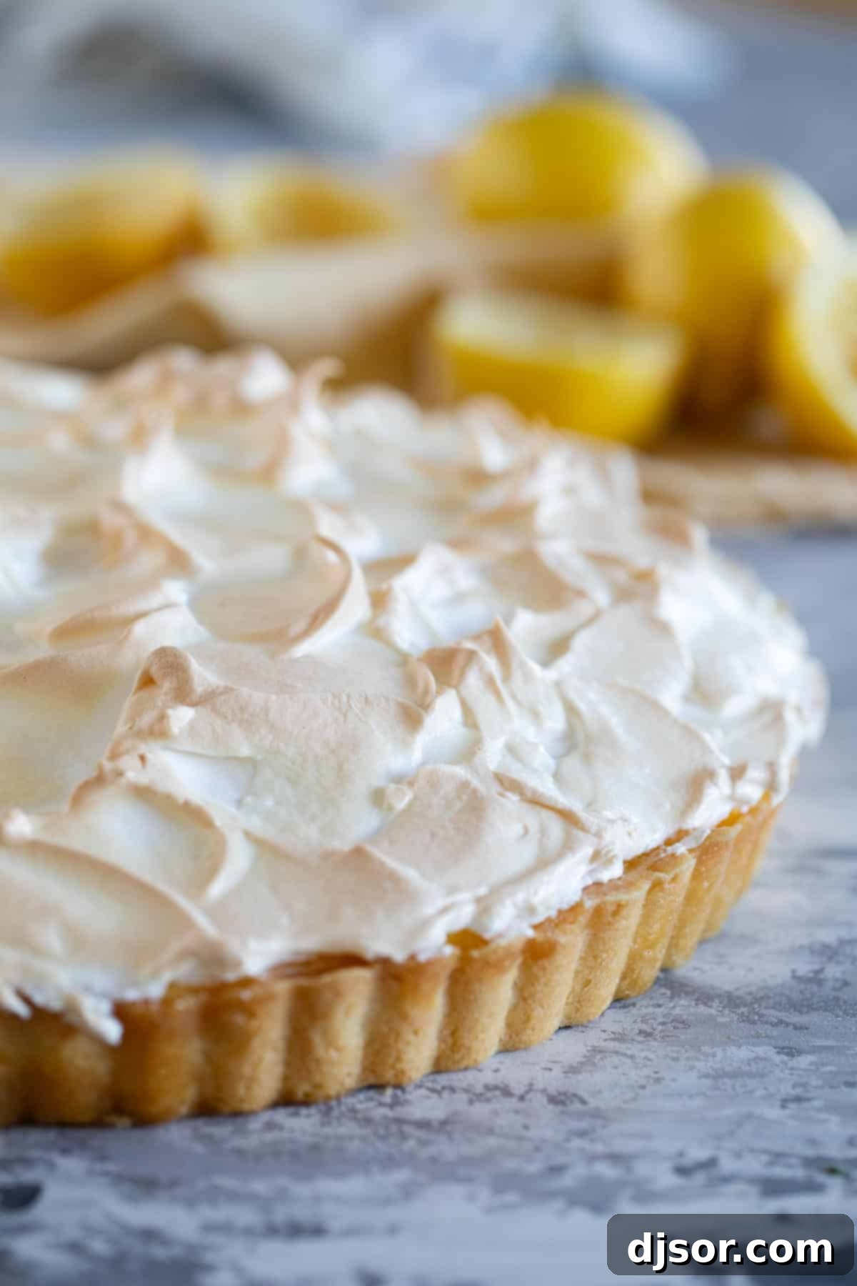 A stunning full French Lemon Cream Tart, beautifully topped with golden-brown, artfully swirled meringue.